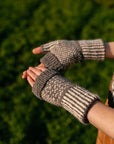 a close up image of a pair of colourwork mitts knit in sheepy shades. 