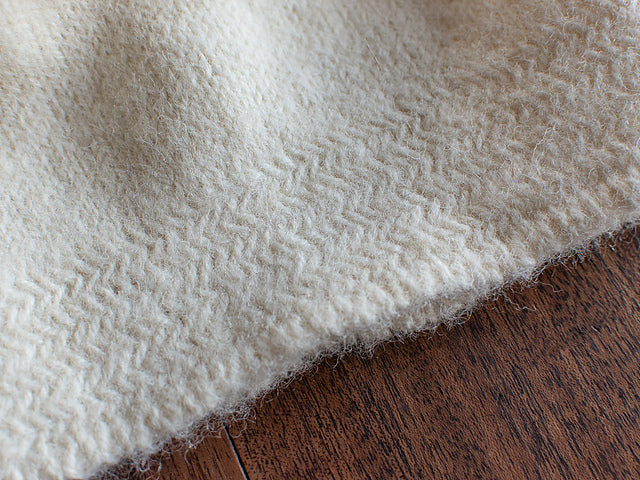 a close up shot of the herringbone detail at the edge of a felted knit hat