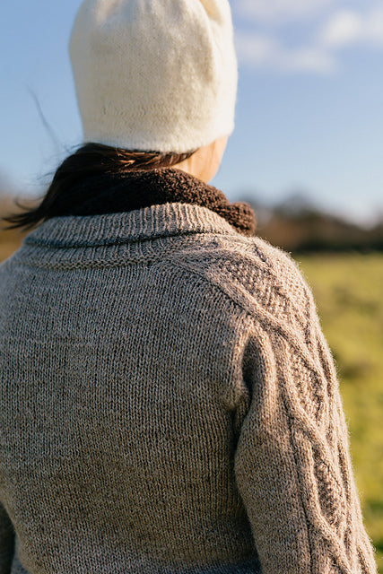 a close up shot of the shoulder and collar detail on a handknit cardigan made using British wool